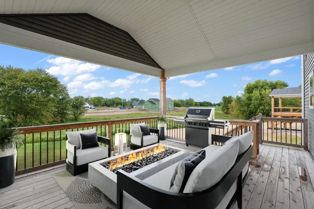 a view of a balcony with chairs and wooden floor