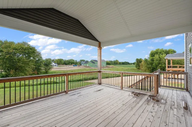 a view of balcony with wooden floor and fence