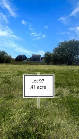 a sign of golf club on a wall under a large tree
