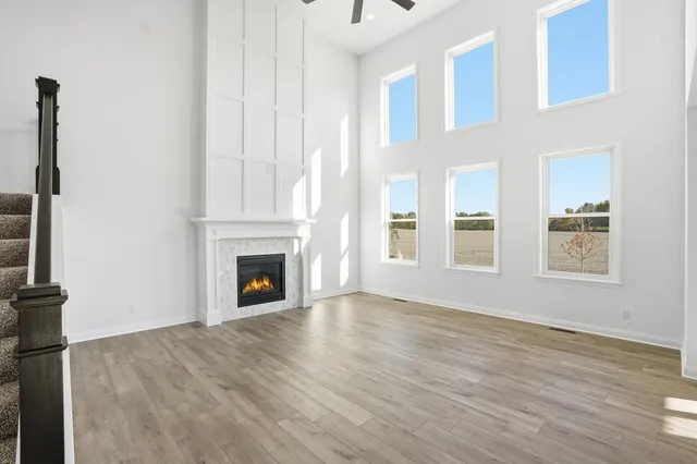 a view of a livingroom with wooden floor and a fireplace