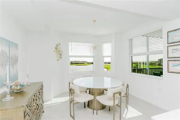 a view of a dining room with furniture and a potted plant