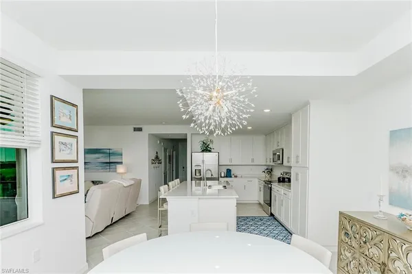 a bedroom with a bed and painting on the wall