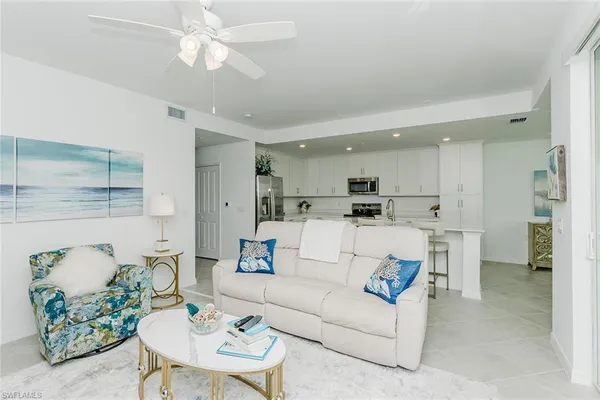 a view of a dining room kitchen with furniture and a chandelier