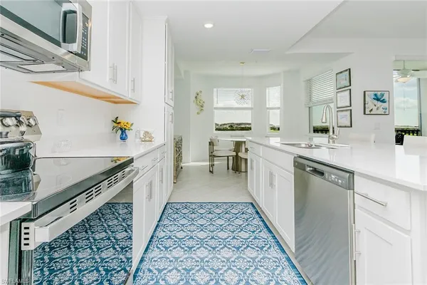 a kitchen with a sink stove and cabinets