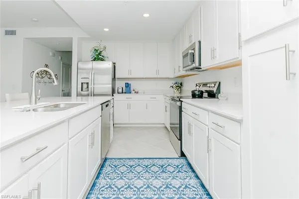 a kitchen with granite countertop a sink and cabinets