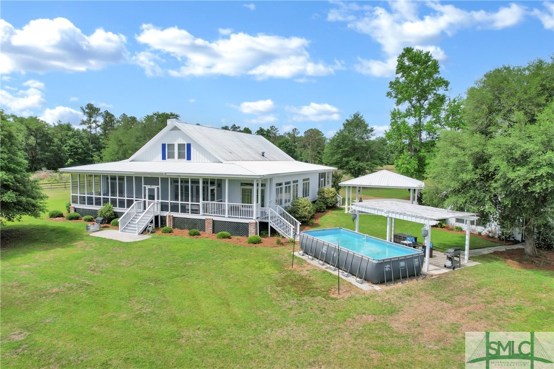 1600 Arcola Road Pembroke, GA 31321 - Photo 8 of 50 The exterior view of the home with pool & pergola