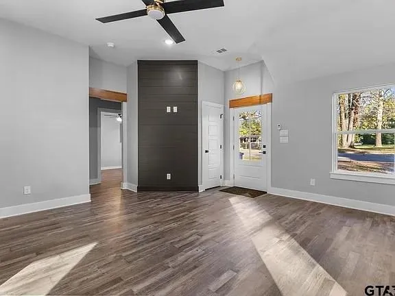 wooden floor in an empty room with a window