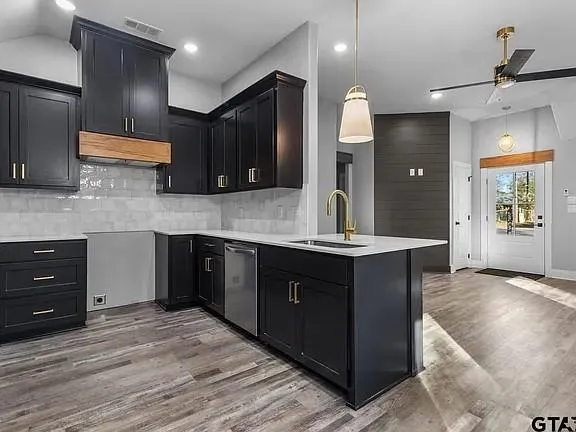 a kitchen with kitchen island granite countertop a large counter top sink and stainless steel appliances