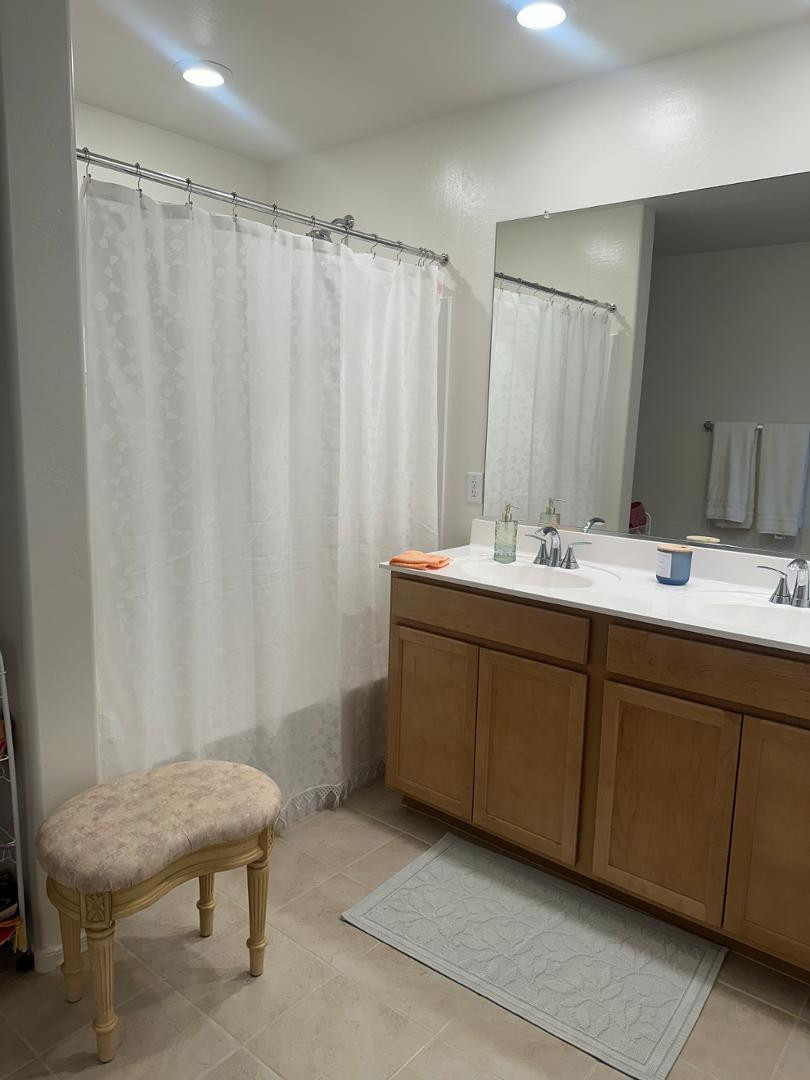 18255 West Pima Street Goodyear, AZ 85338 - Photo 7 of 12 a en suite bathroom with a double vanity sink and a toilet