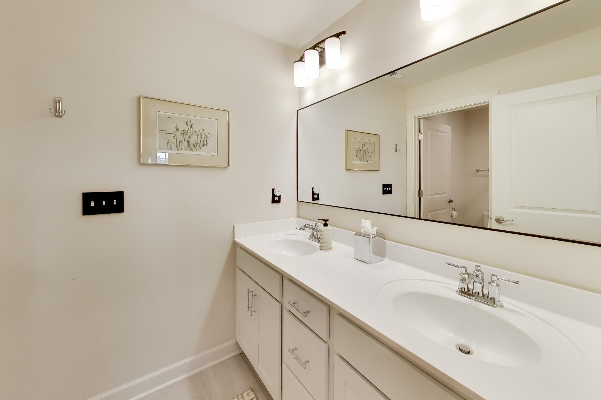 2730 Harbor Court Delavan, WI 53115 - Photo 32 of 47 Upper-level shared bath with double vanity, wide mirror, vanity lighting, and neutral tile flooring.