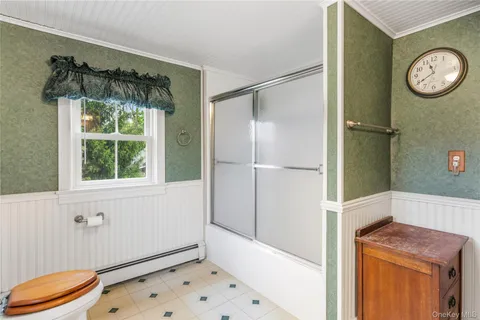 a view of bathroom with a window and tub