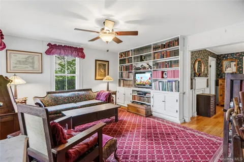 a living room with furniture a flat screen tv and a rug