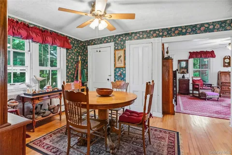a dining room with furniture a chandelier and wooden floor