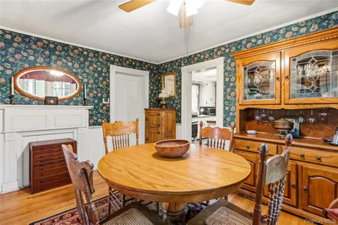 a dining room with furniture and wooden floor