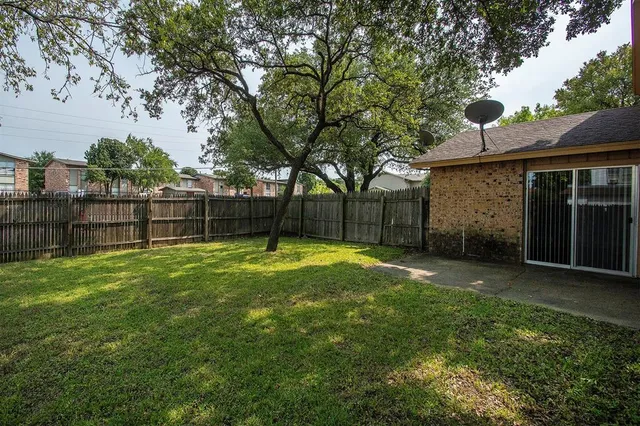 a view of a backyard with a small cabin and a chair