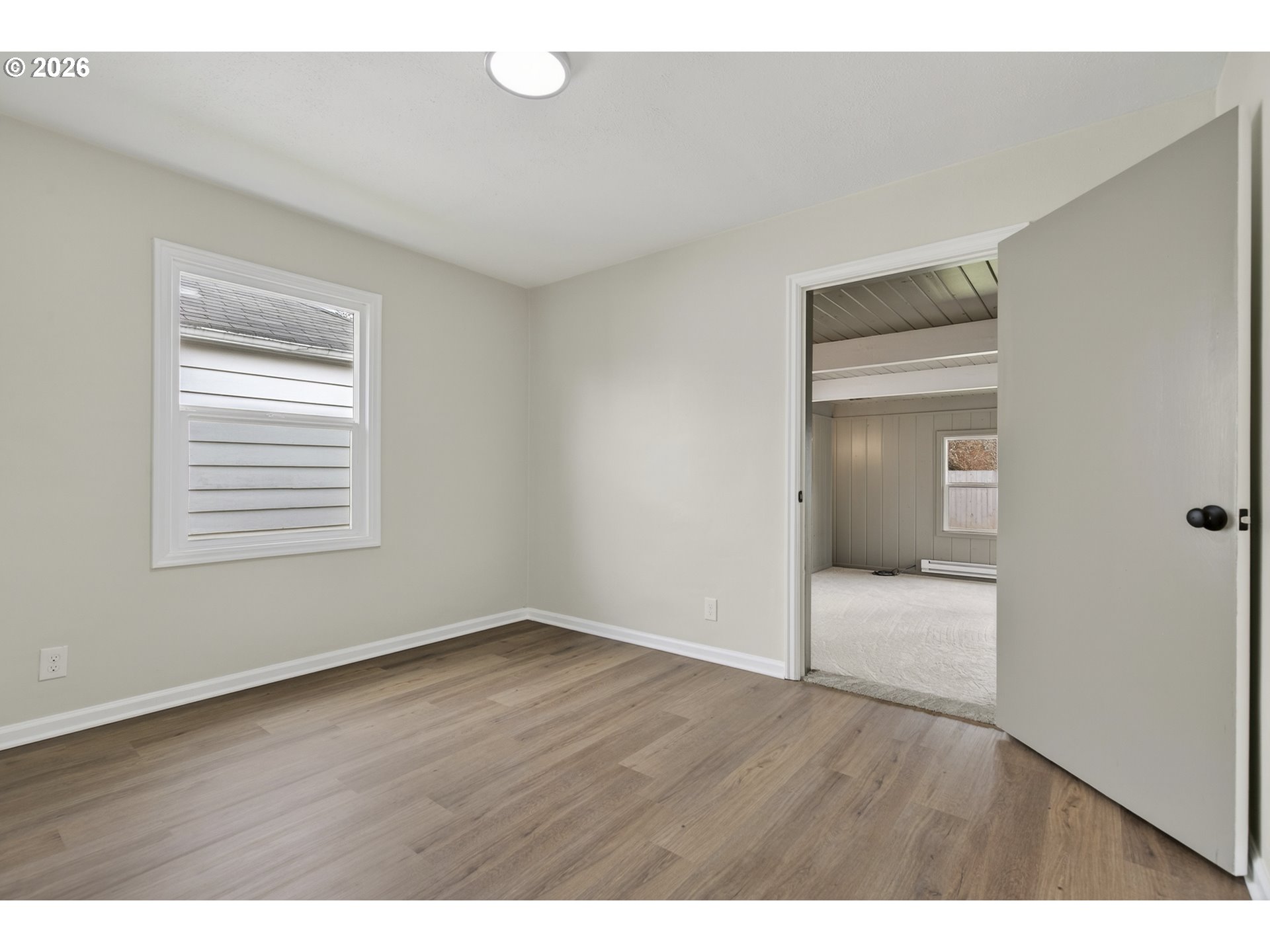 520 24th Avenue Longview, WA 98632 - Photo 25 of 37 a view of an empty room with wooden floor and a window