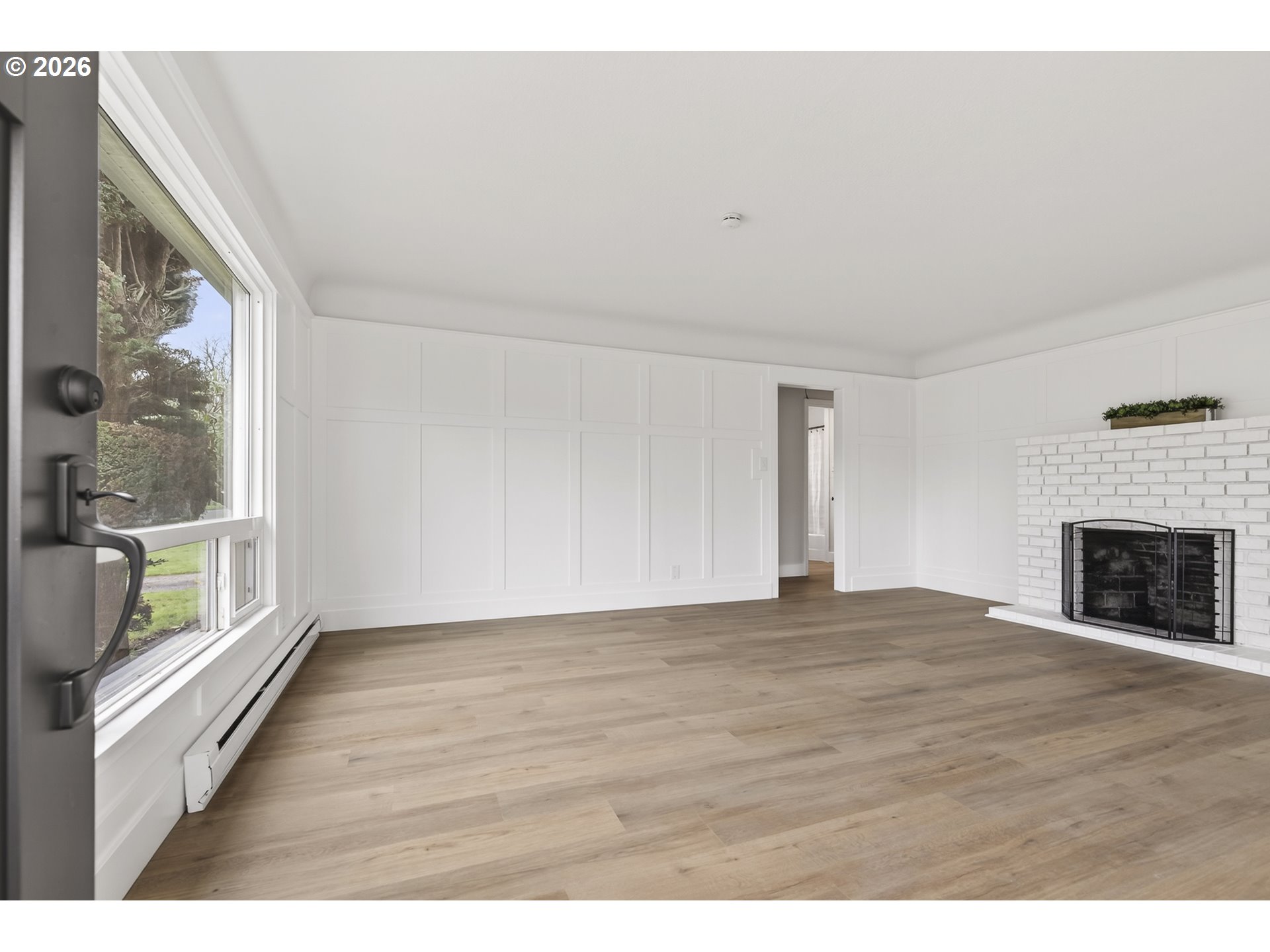 520 24th Avenue Longview, WA 98632 - Photo 5 of 37 a view of an empty room with wooden floor and a window