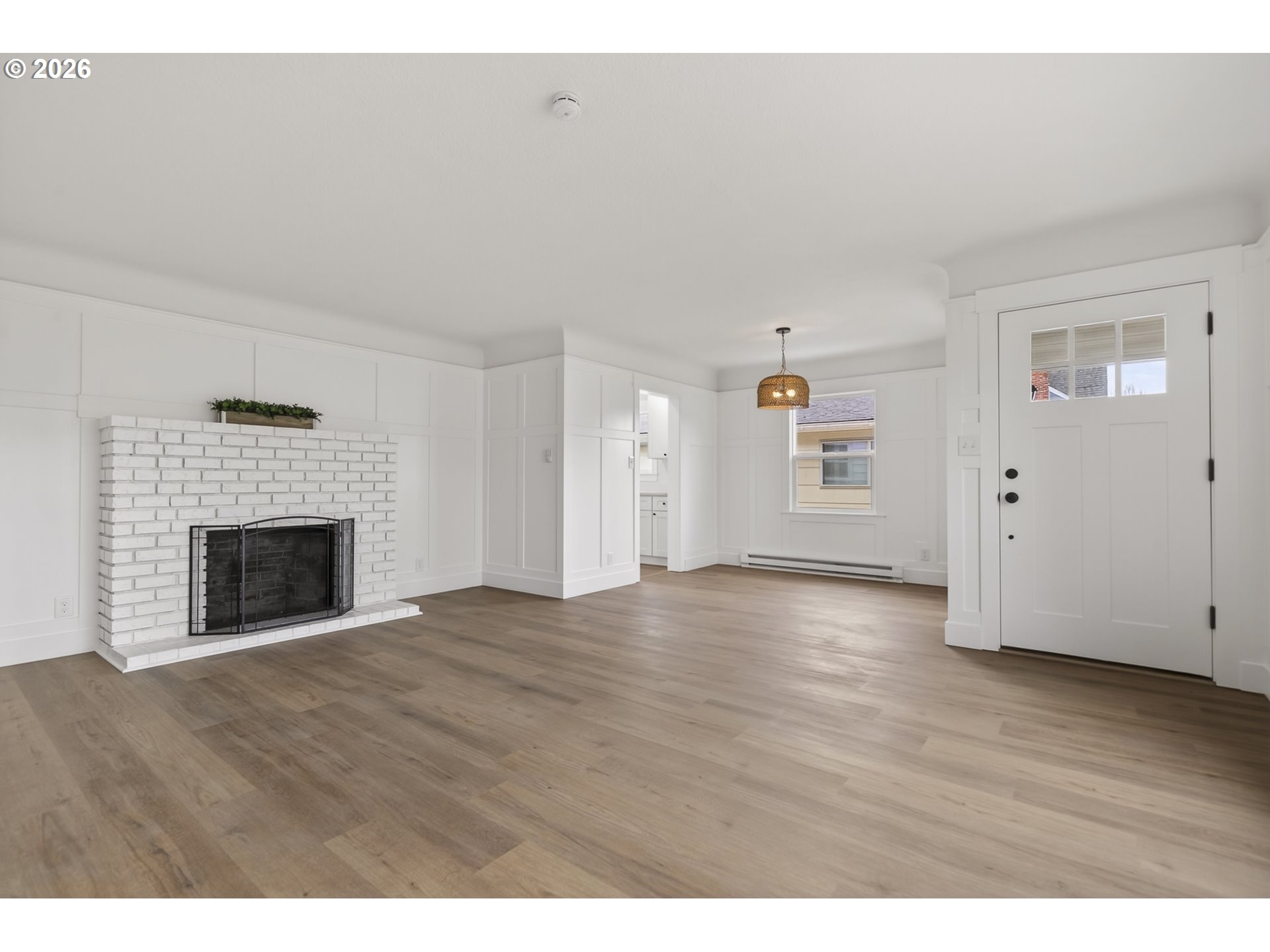 520 24th Avenue Longview, WA 98632 - Photo 6 of 37 a view of an empty room with wooden floor fireplace and a window
