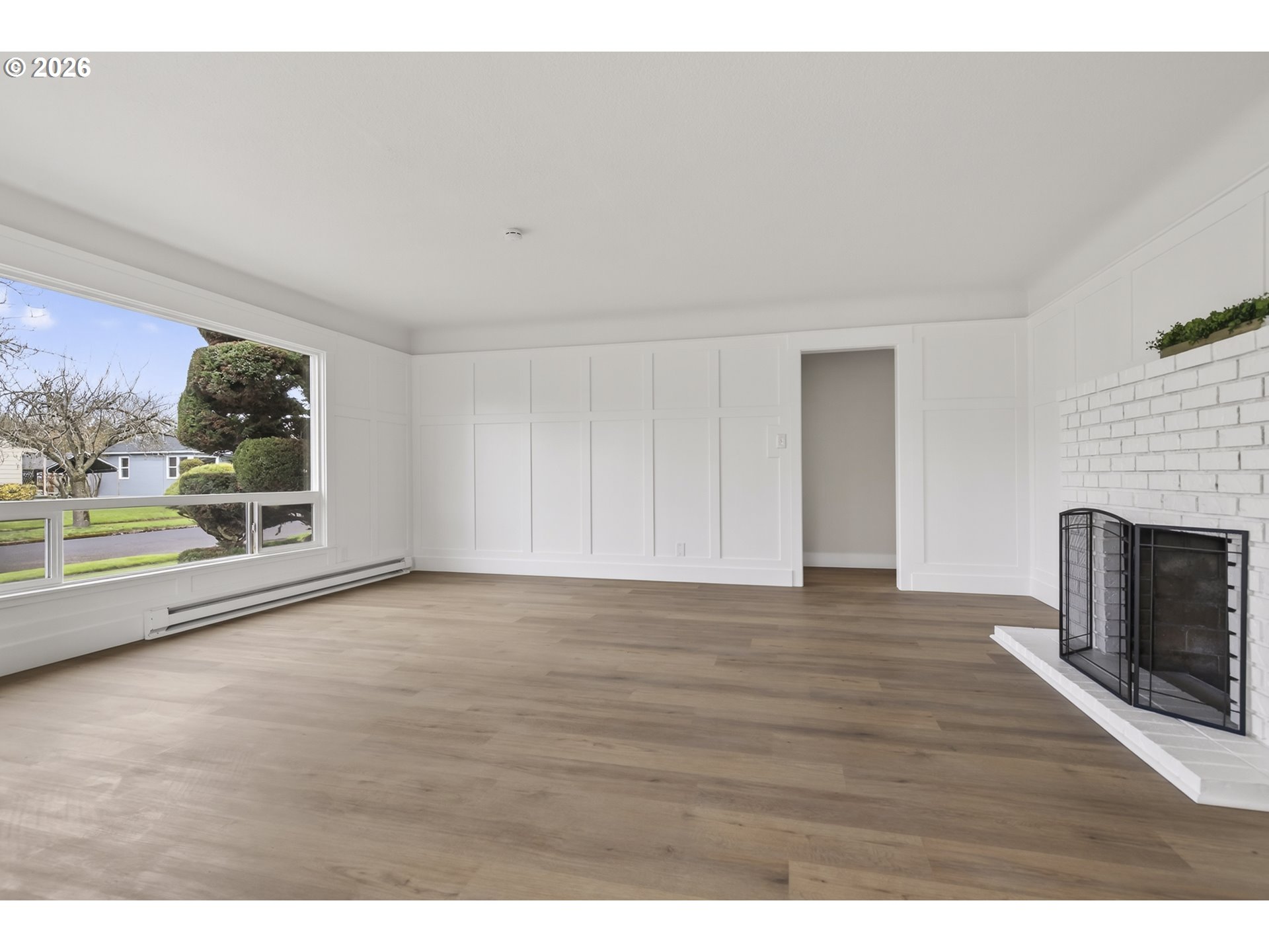 520 24th Avenue Longview, WA 98632 - Photo 8 of 37 a view of an empty room with a fireplace and a window