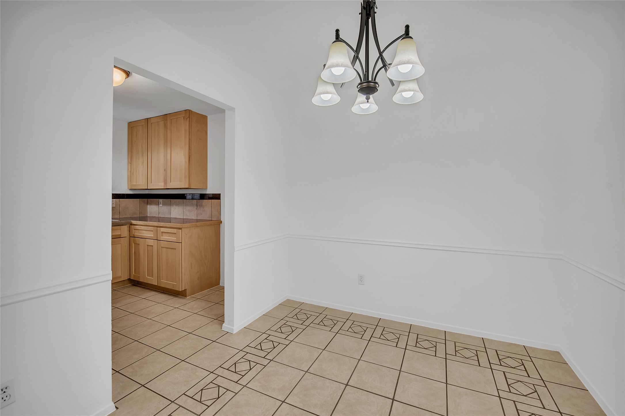 7209 Gunnison Pass Austin, TX 78724 - Photo 5 of 19 A classic chandelier illuminates the dining area, featuring an open concept adjacent to the kitchen.