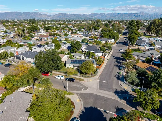 an aerial view of residential houses with outdoor space and trees