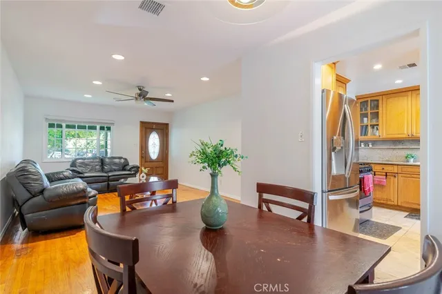 a living room with furniture kitchen view and a large window