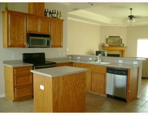 a kitchen with a sink a stove and a microwave