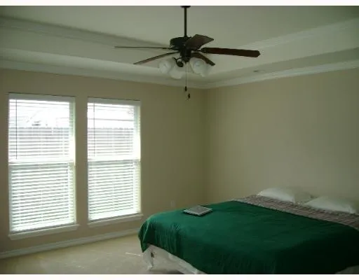 a room with a window and a ceiling fan