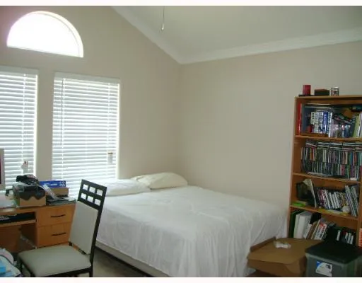 a bedroom with a bed and a book shelf