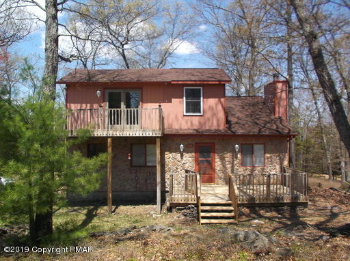 143 Weasel Road Dingmans Ferry, PA 18328 - Photo 1 of 14 a front view of a house with a garden