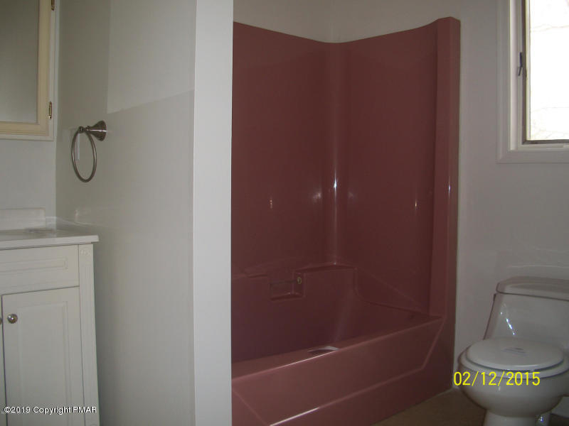 143 Weasel Road Dingmans Ferry, PA 18328 - Photo 12 of 14 a bathroom with a bathtub and a shower
