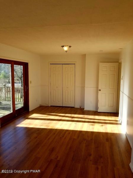 143 Weasel Road Dingmans Ferry, PA 18328 - Photo 6 of 14 a view of room with wooden floor and window