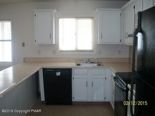 143 Weasel Road Dingmans Ferry, PA 18328 - Photo 10 of 14 a kitchen with a sink stove and refrigerator