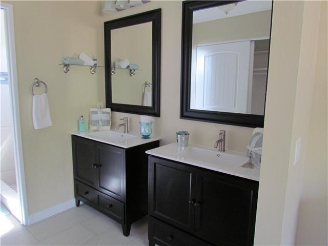 1512 Monte Mar Road Vista, CA 92084 - Photo 11 of 22 Master bathroom completely renovated with new vanities and countertops, mirrors, light fixtures, tile flooring and shower surround with decorative stone/glass border inlay.