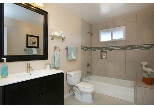 1512 Monte Mar Road Vista, CA 92084 - Photo 13 of 22 Hallway bath completely remodeled, new vanity and countertop, fixtures, tile flooring & shower surround with decorative stone/glass border inlay.