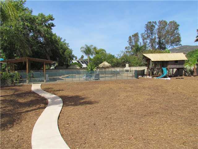 1512 Monte Mar Road Vista, CA 92084 - Photo 17 of 22 Large backyard with sidewalk leading out to the entertainment area (pool,spa,fireplace,bbq island, kid's playhouse)