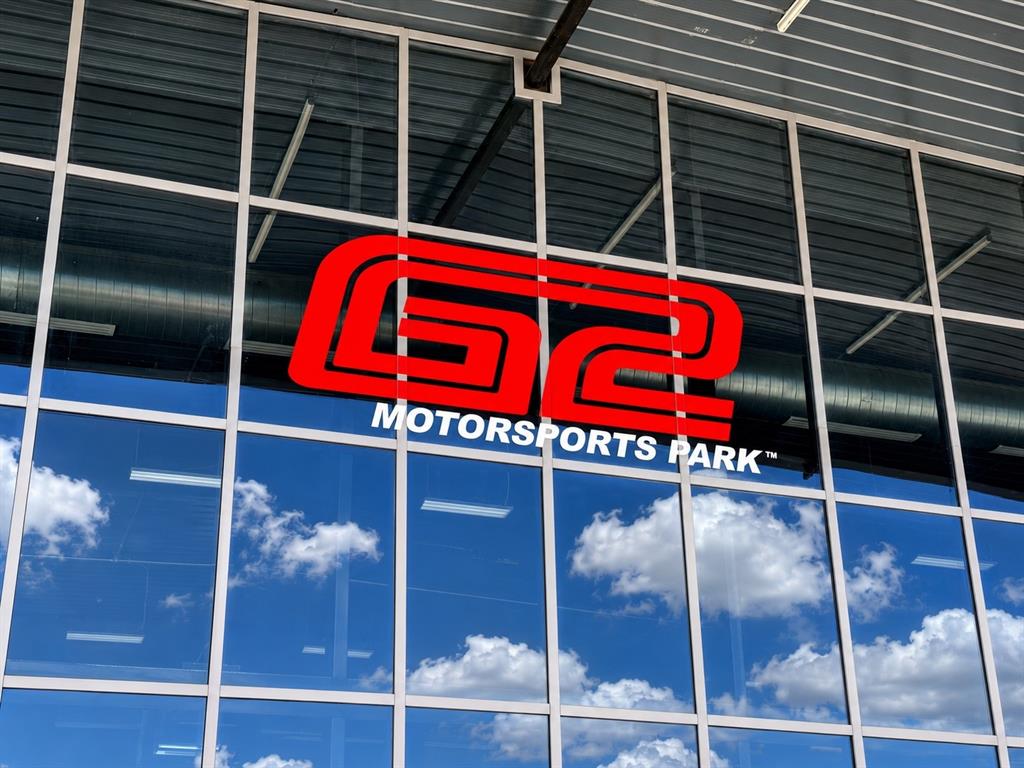 400 Fast Lane, Unit 4 Anna, TX 75409 - Photo 9 of 9 Modern glass storefront featuring a red "G2 MOTORSPORTS PARK" logo