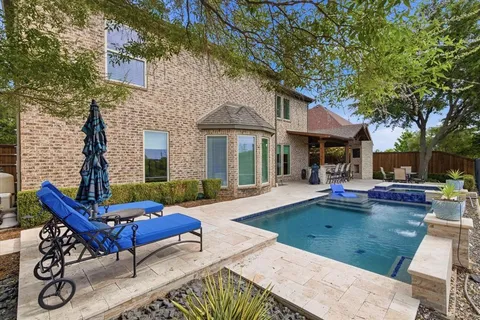 a view of a house with swimming pool and sitting area