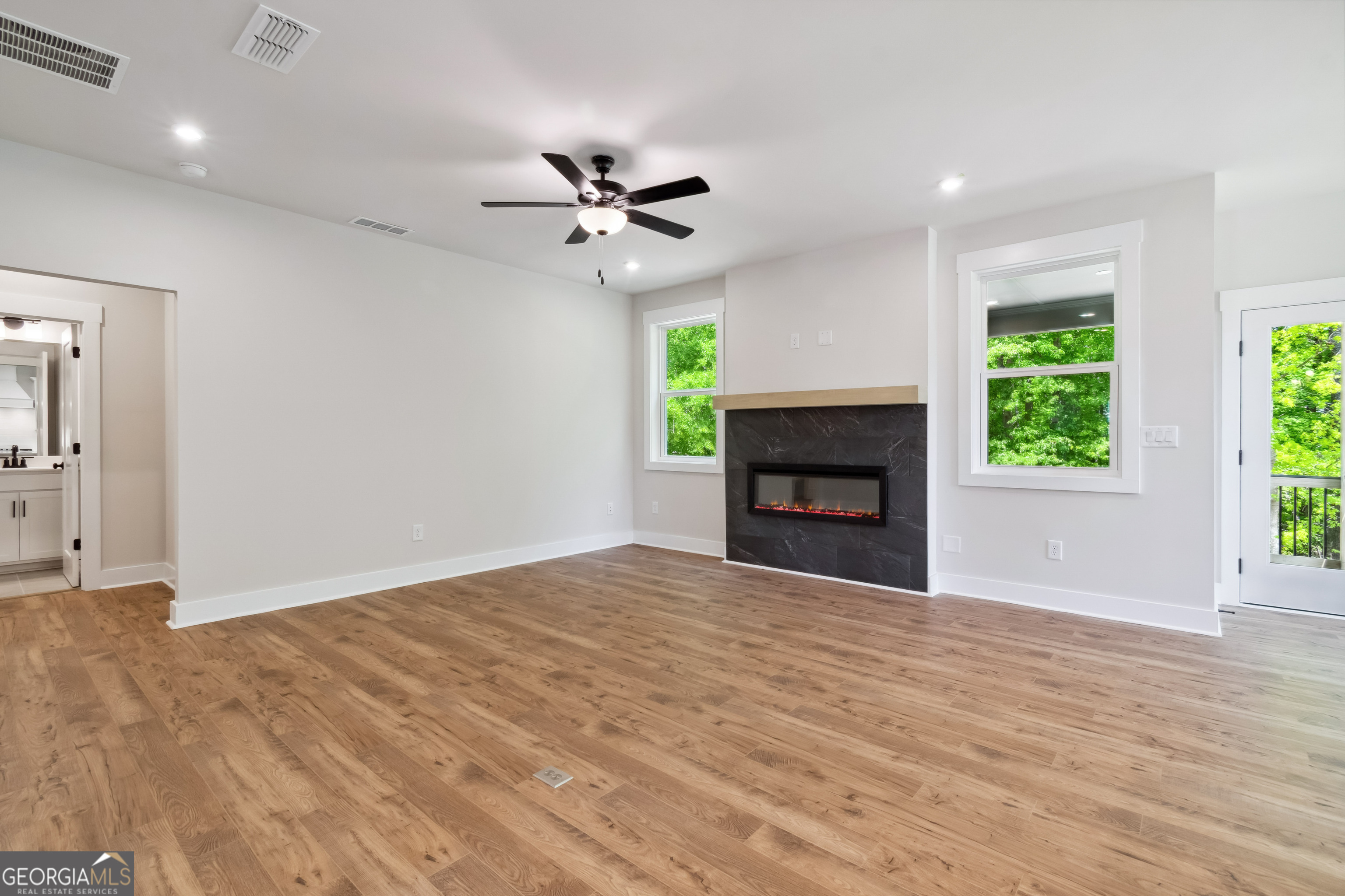 4002 Adler Circle, Unit 7 Buford, GA 30519 - Photo 14 of 38 a view of empty room with fireplace and wooden floor