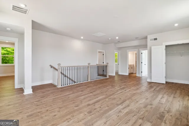 a view of an empty room with wooden floor