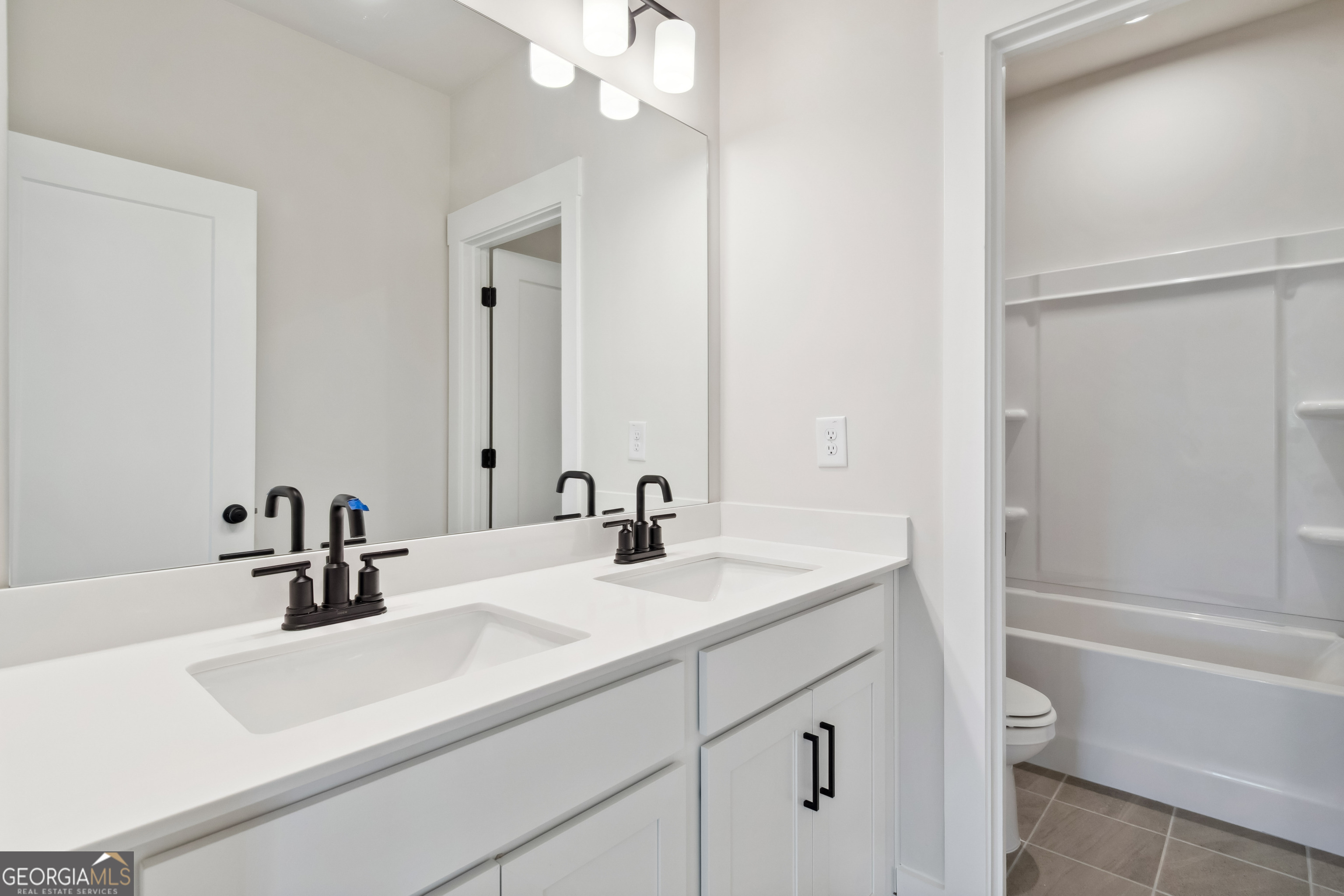 4002 Adler Circle, Unit 7 Buford, GA 30519 - Photo 25 of 38 a bathroom with a sink a toilet and shower