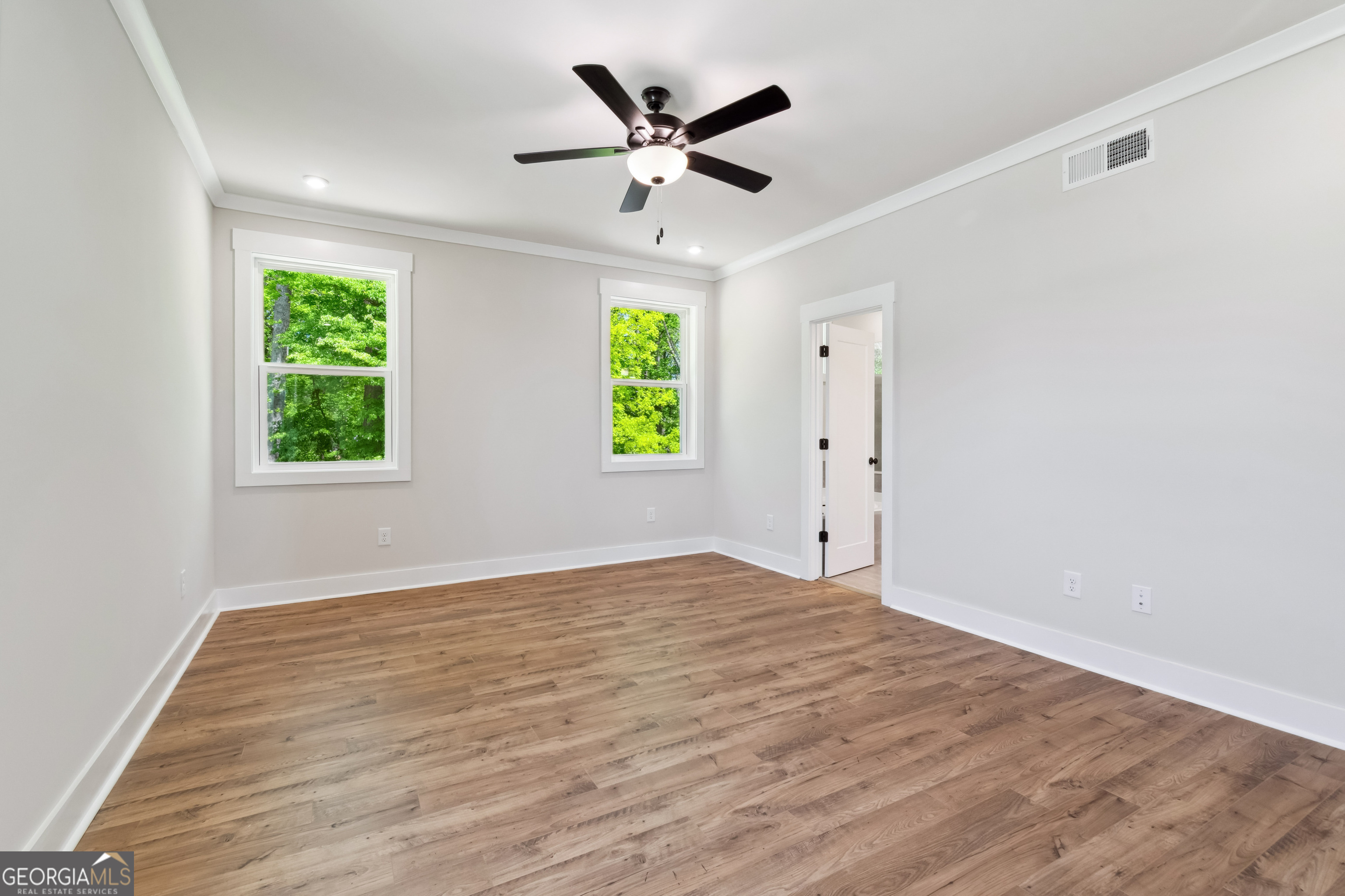 4002 Adler Circle, Unit 7 Buford, GA 30519 - Photo 27 of 38 an empty room with window and a ceiling fan
