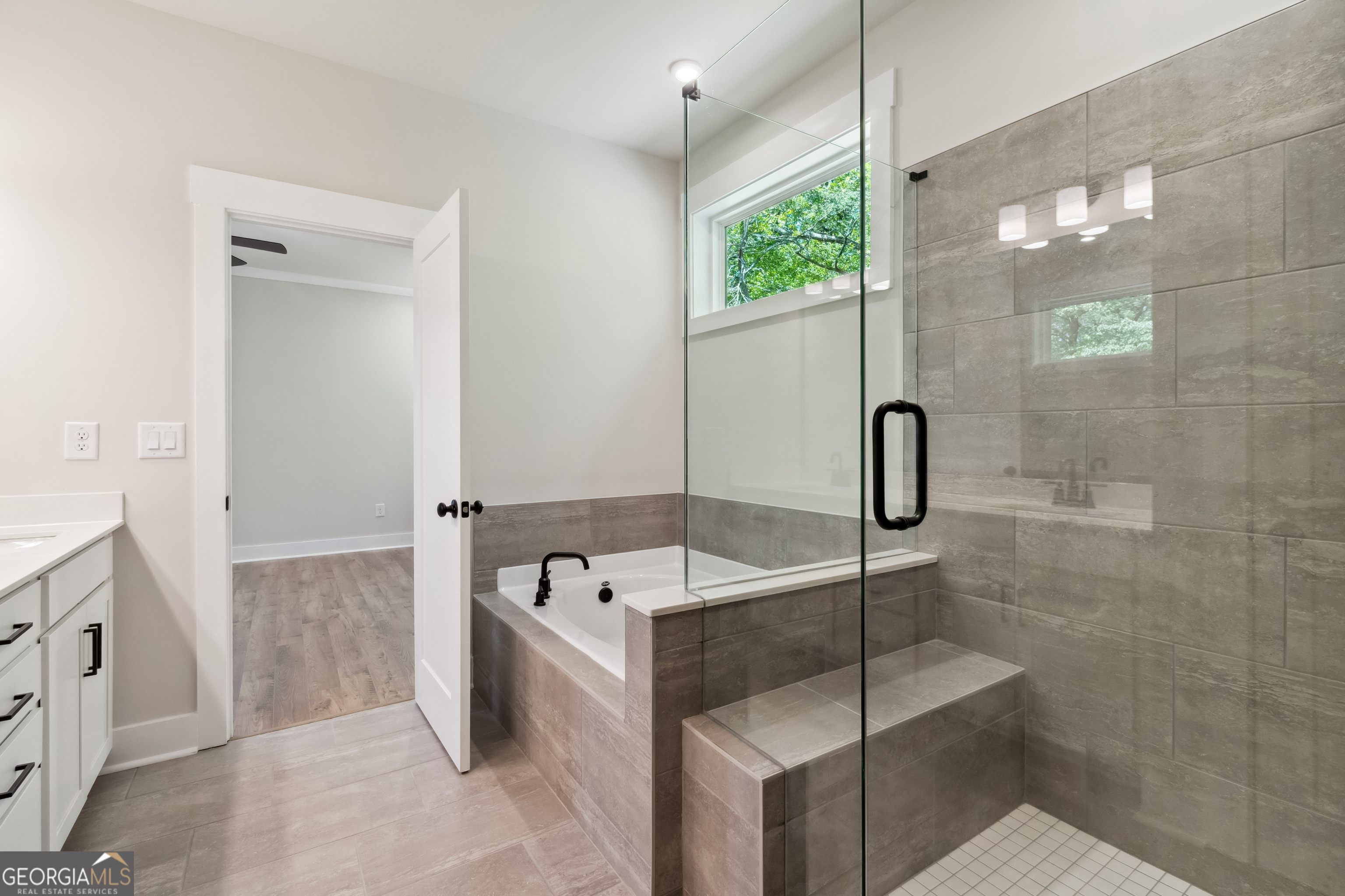 4002 Adler Circle, Unit 7 Buford, GA 30519 - Photo 31 of 38 a bathroom with a tub and a shower