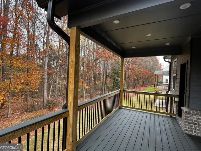a view of a balcony with wooden floor