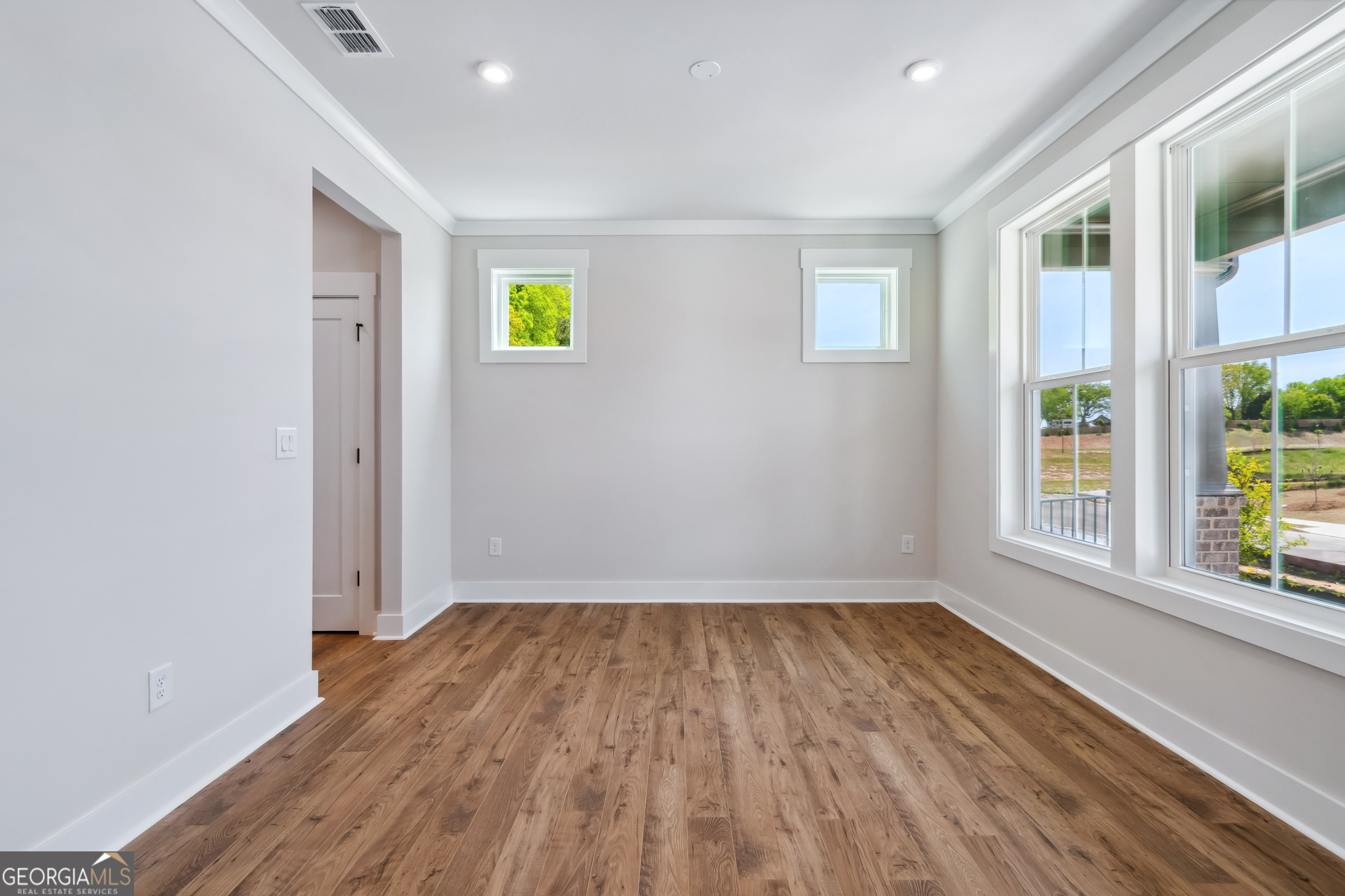4002 Adler Circle, Unit 7 Buford, GA 30519 - Photo 5 of 38 a view of empty room with wooden floor and fan