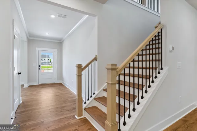 a view of an entryway with wooden floor