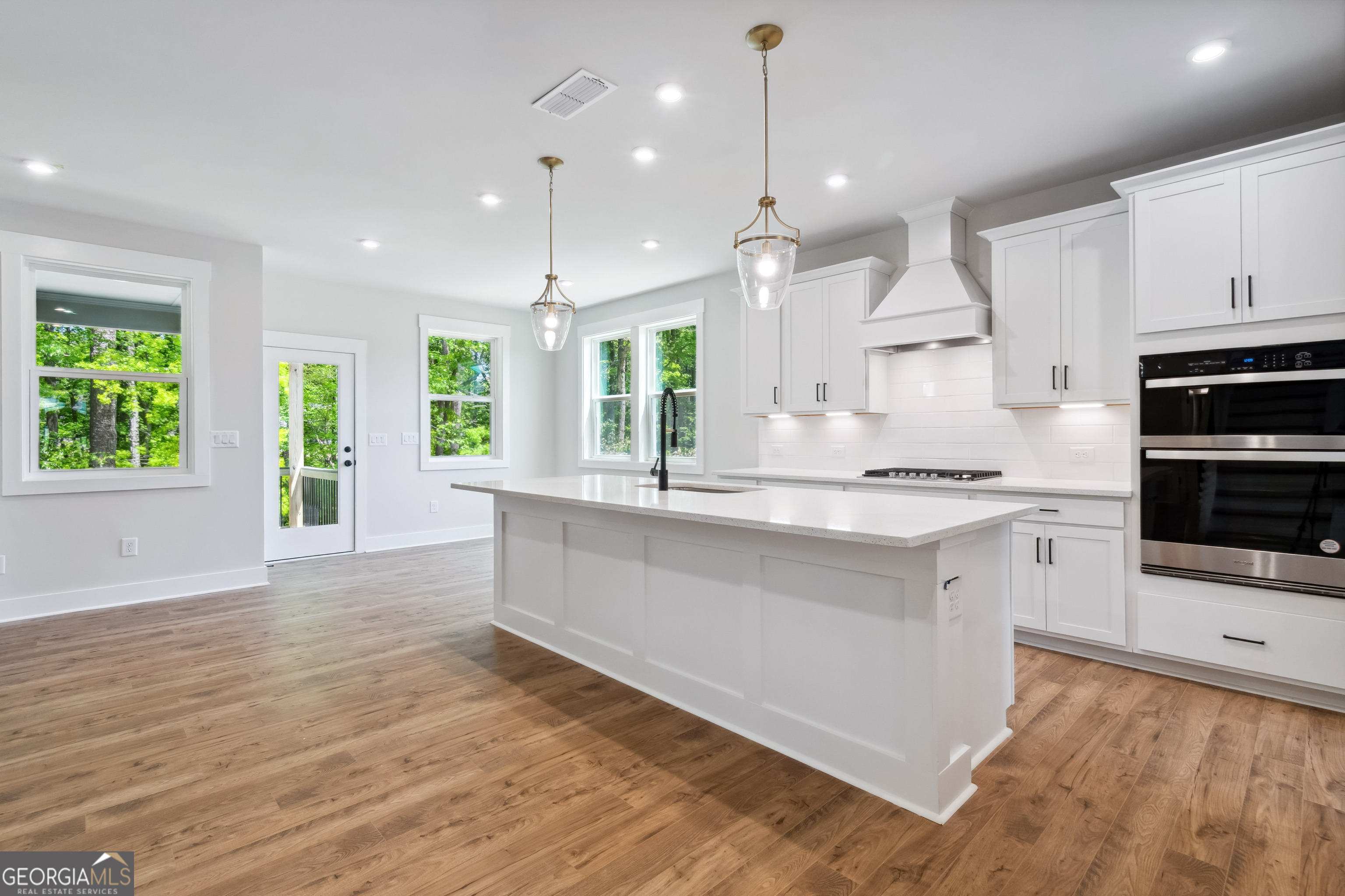 4002 Adler Circle, Unit 7 Buford, GA 30519 - Photo 7 of 38 a large kitchen with granite countertop a large counter top appliances and cabinets
