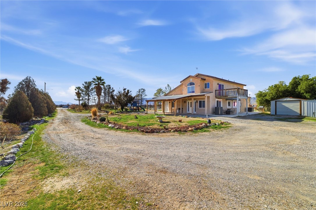 2570 East Kellogg Road Pahrump, NV 89048 - Photo 7 of 54 Large circular driveway. Carport. Entertaining area. Storage shed on 1.25-acre, fully fenced property.