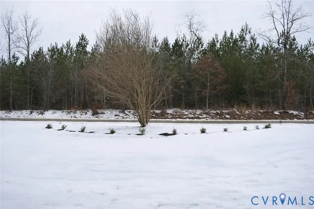 a white house with snow on the side of a road