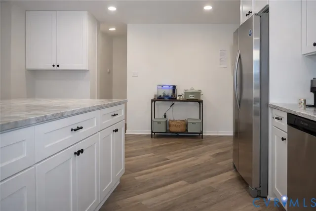 a view of a kitchen with furniture and wooden floor